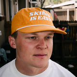 "SKIING IS EASY" | HAT (RUST)